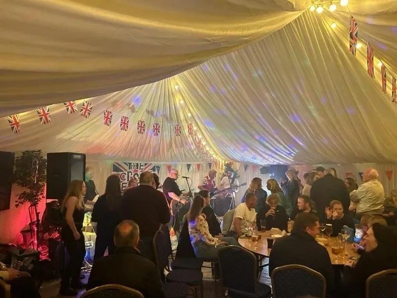 Crowd celebrating with a live band at a party
