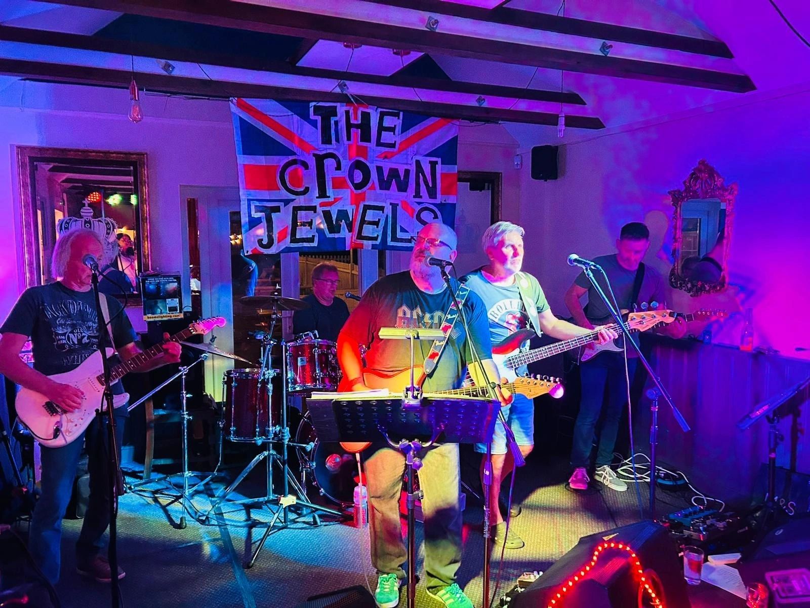 Drummer performing live under stage lights